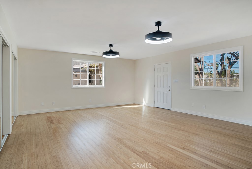 7635 Fallbrook Avenue West Hills, CA 91304 - Photo 21 of 26 a view of an empty room with wooden floor and a window