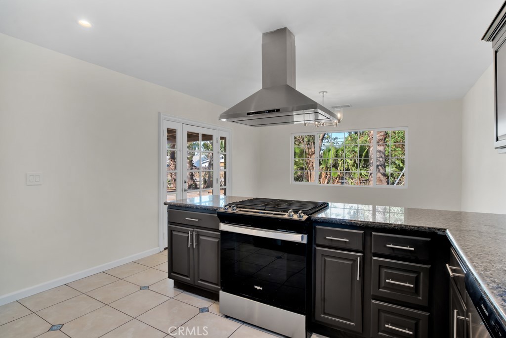 7635 Fallbrook Avenue West Hills, CA 91304 - Photo 5 of 26 a kitchen with granite countertop a stove and a sink
