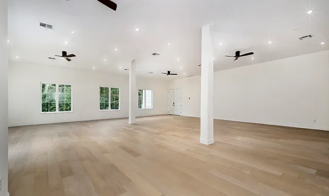 a view of a kitchen with white cabinets