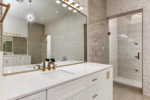 a bathroom with a tub sink shower and mirror