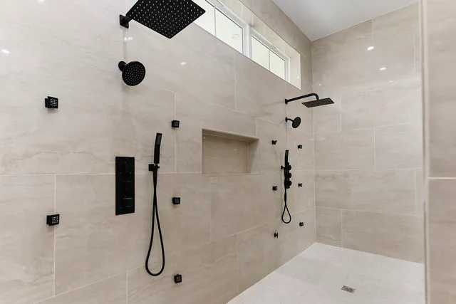 a living room with furniture and floor to ceiling window