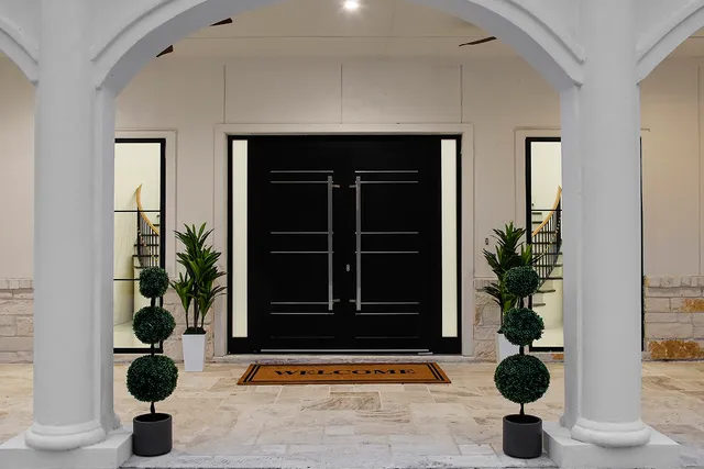 a view of entryway door with potted plant in front of it