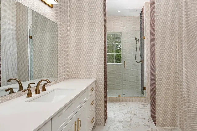 a spacious bedroom with a bed and a flat tv screen