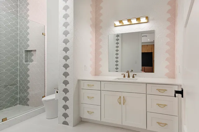 a bedroom with a large bed and a flat tv screen