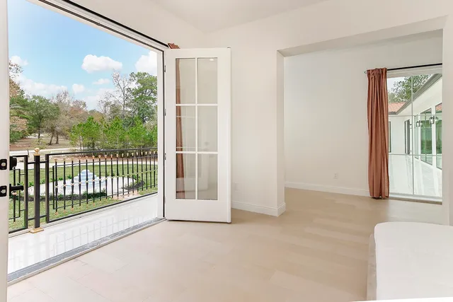 a bedroom with a large bed and a chandelier