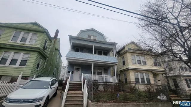 a front view of a house with many windows