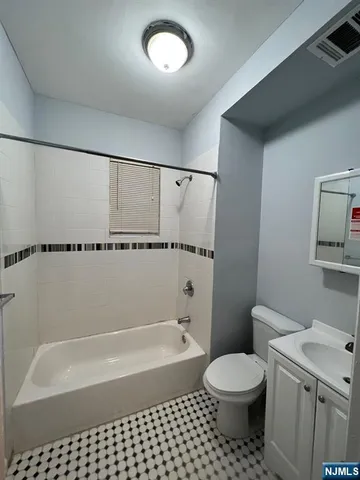 a bathroom with a toilet and a bathtub