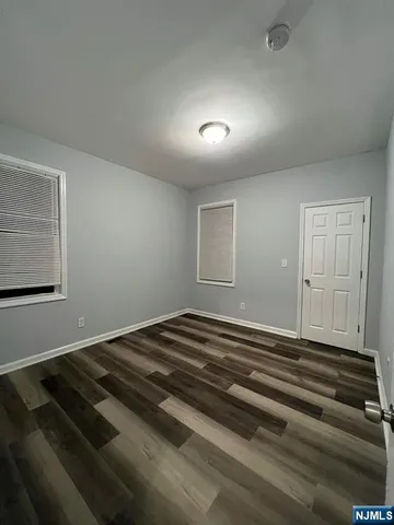 a view of a livingroom with wooden floor and closet