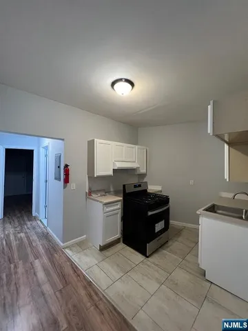 a kitchen with a stove and a refrigerator