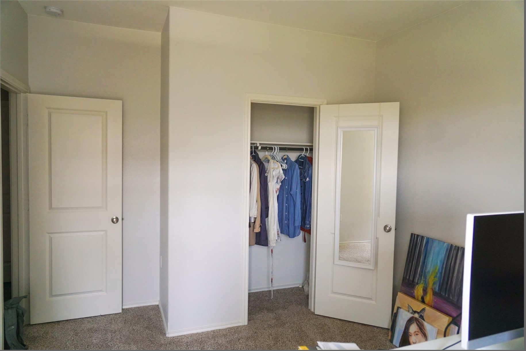 2321 Forgetmenot Lane Manor, TX 78653 - Photo 21 of 27 Functional bedroom featuring carpet flooring and ample closet space with mirrored door.