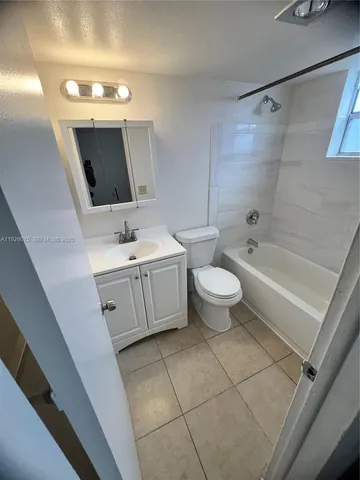 a bathroom with a double vanity sink mirror and toilet