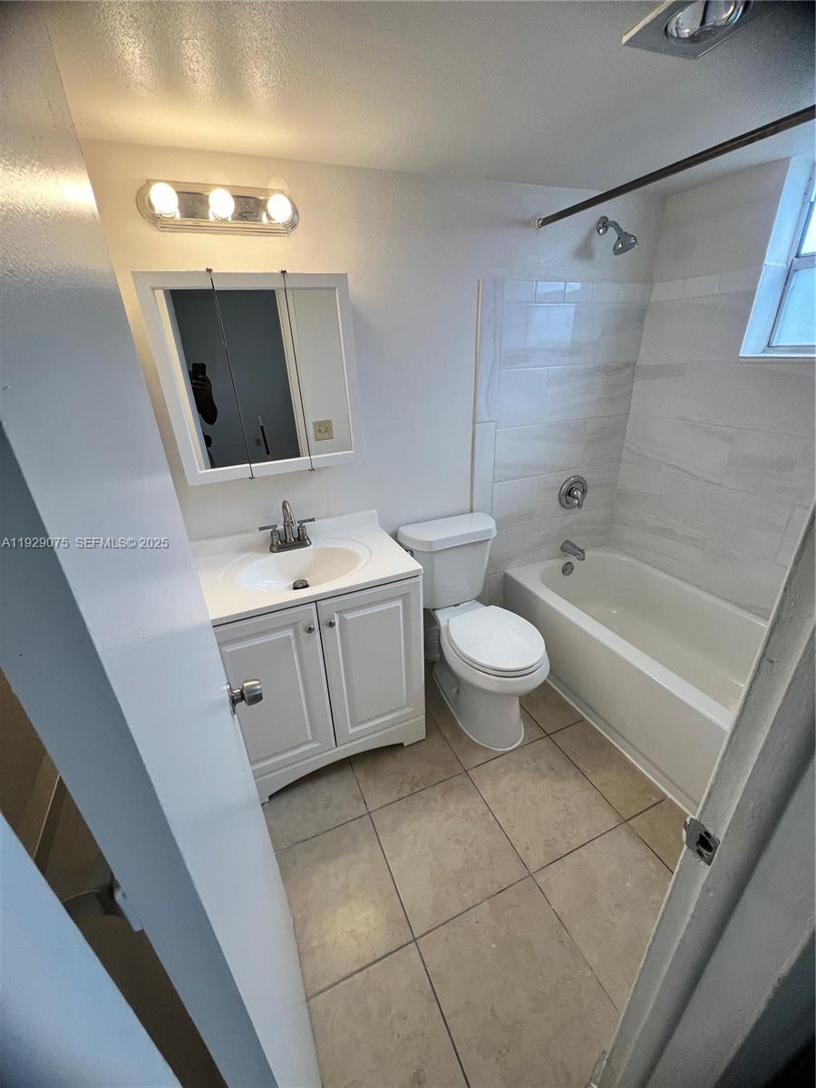 12905 Arch Creek Road, Unit 3 North Miami, FL 33161 - Photo 2 of 8 a bathroom with a double vanity sink mirror and toilet