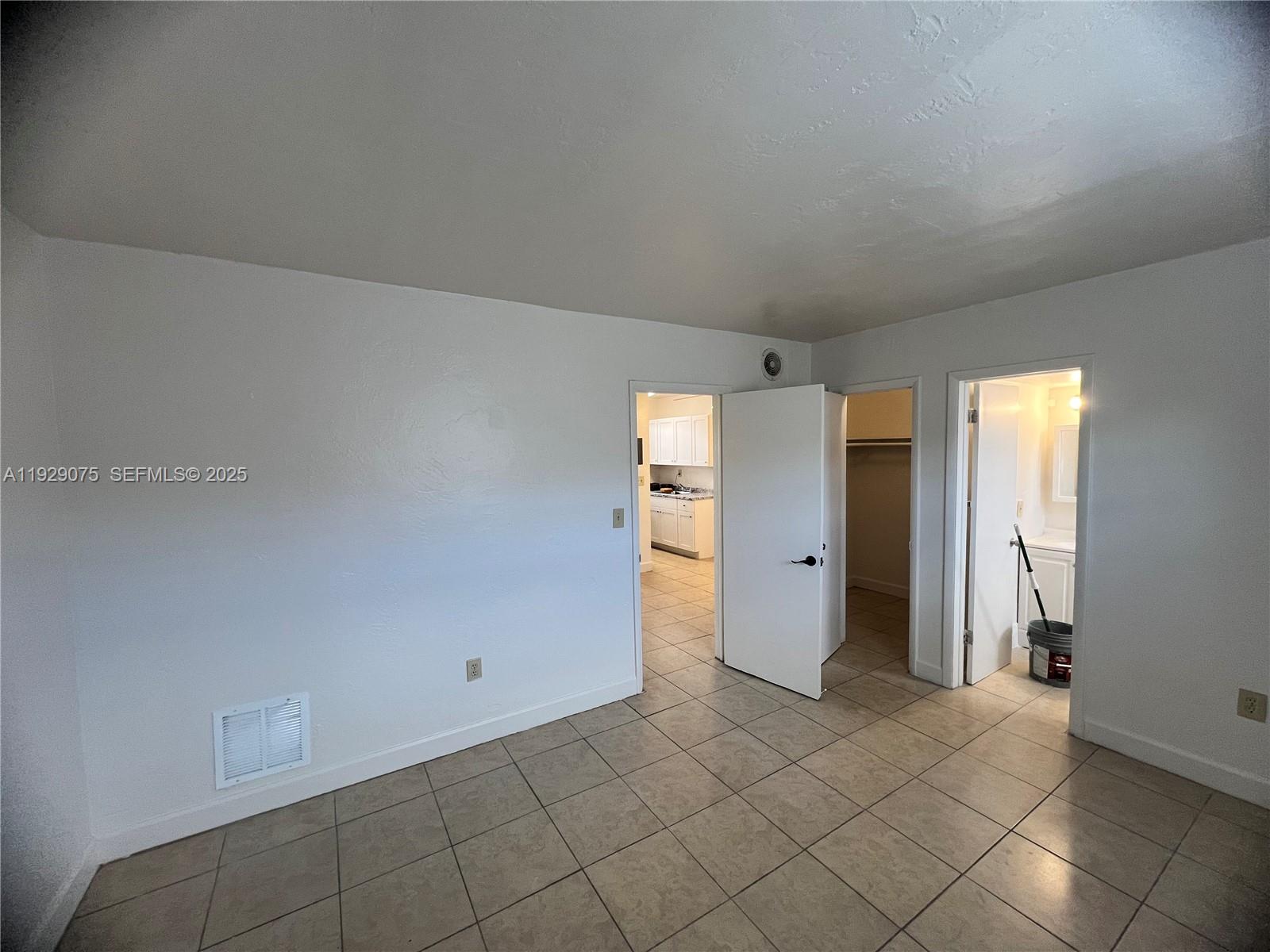 12905 Arch Creek Road, Unit 3 North Miami, FL 33161 - Photo 5 of 8 a view of a livingroom with an empty space and a window