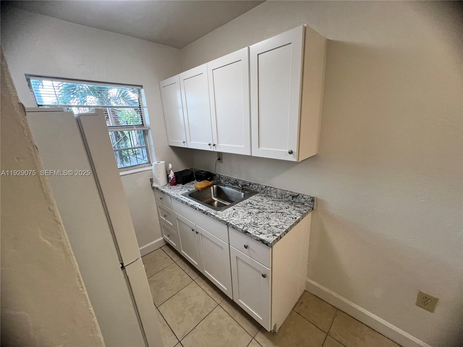 12905 Arch Creek Road, Unit 3 North Miami, FL 33161 - Photo 8 of 8 a view of kitchen with washer and dryer