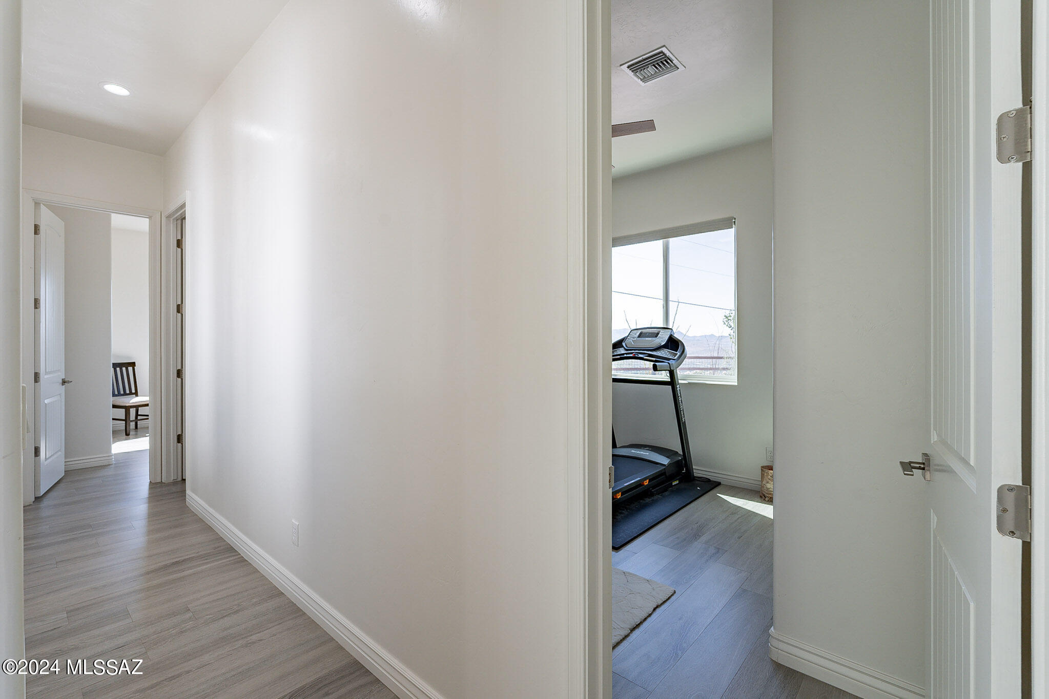176 Avenida Ostion Rio Rico, AZ 85648 - Photo 27 of 48 a view of a hallway with wooden floor and a bathroom