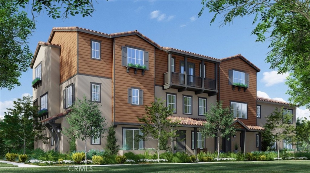 a front view of a house with a yard and potted plants