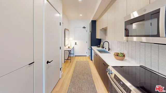 a spacious bathroom with a sink a mirror and shower