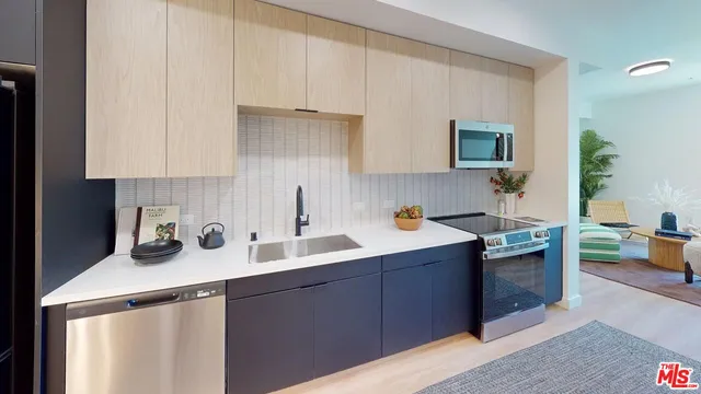 a kitchen with a sink stove and cabinets
