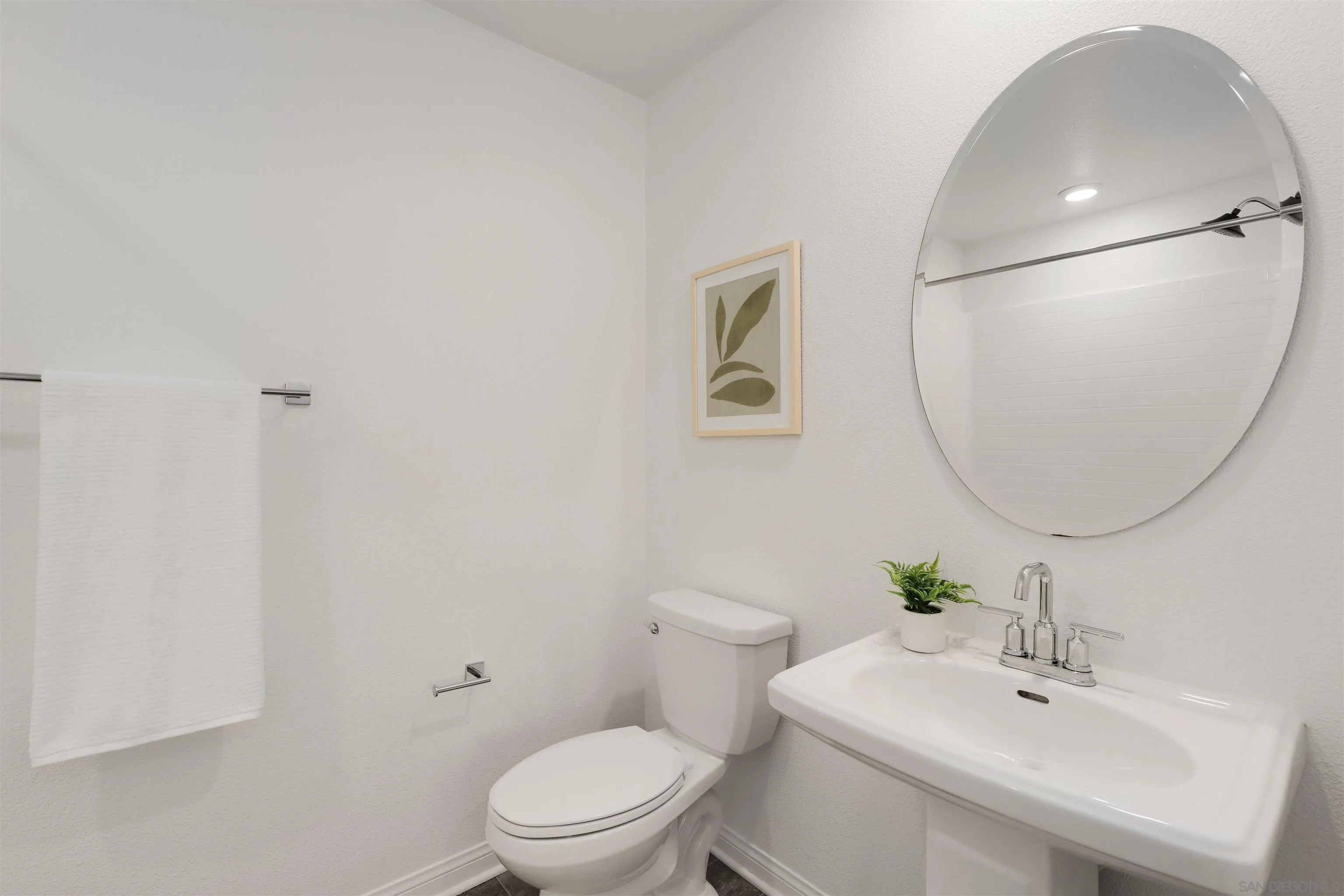 1982 Affinity Lane Chula Vista, CA 91915 - Photo 13 of 34 a white toilet sitting next to a bathroom sink