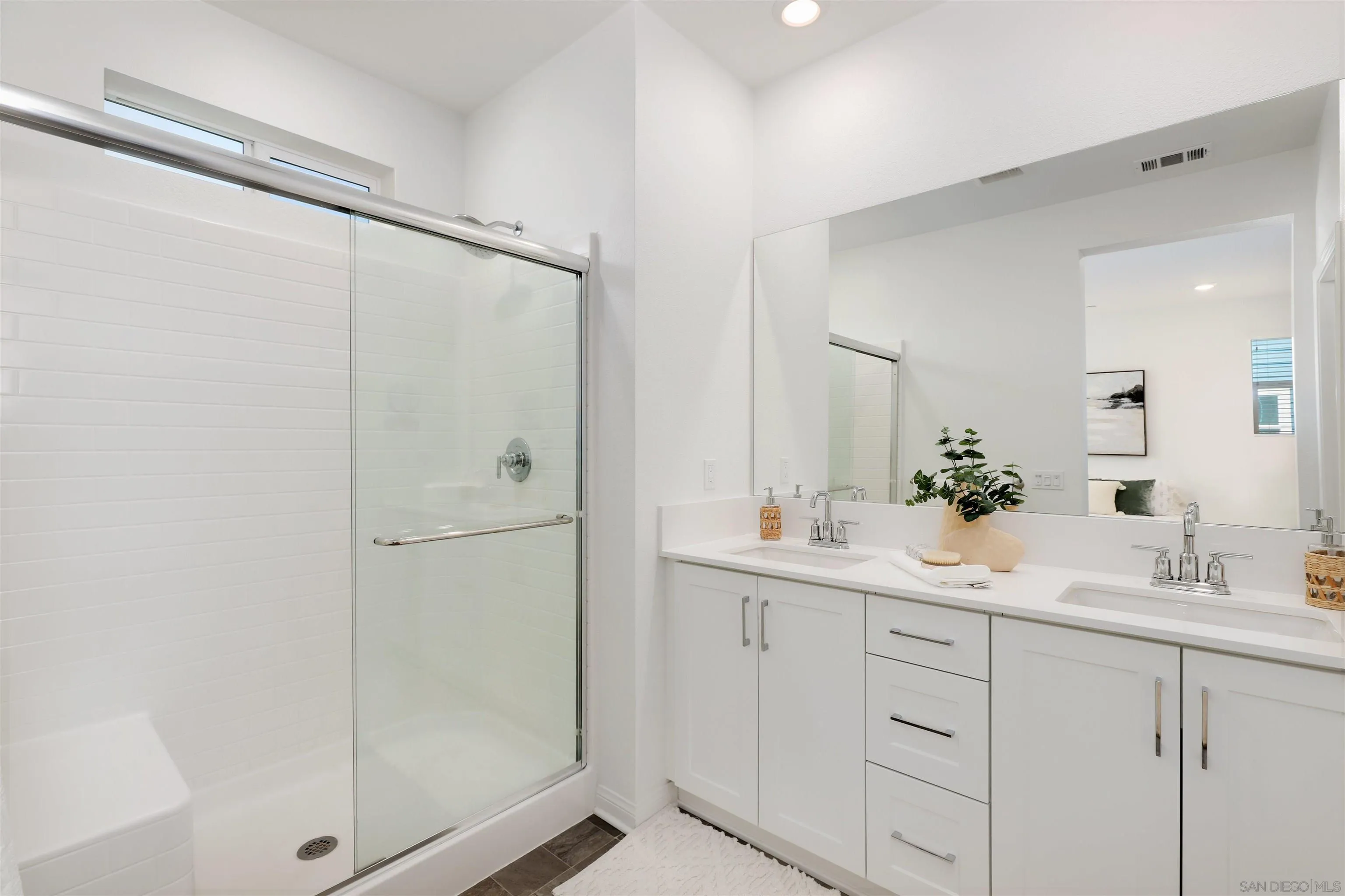 1982 Affinity Lane Chula Vista, CA 91915 - Photo 17 of 34 a bathroom with a shower sink and mirror