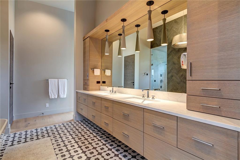 2989 Tiger Road Breckenridge, CO 80424 - Photo 12 of 30 a spacious bathroom with a double vanity sink a mirror and a shower