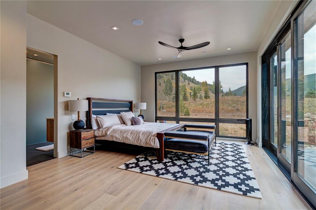 2989 Tiger Road Breckenridge, CO 80424 - Photo 15 of 30 a bedroom with a bed and a large window with wooden floor