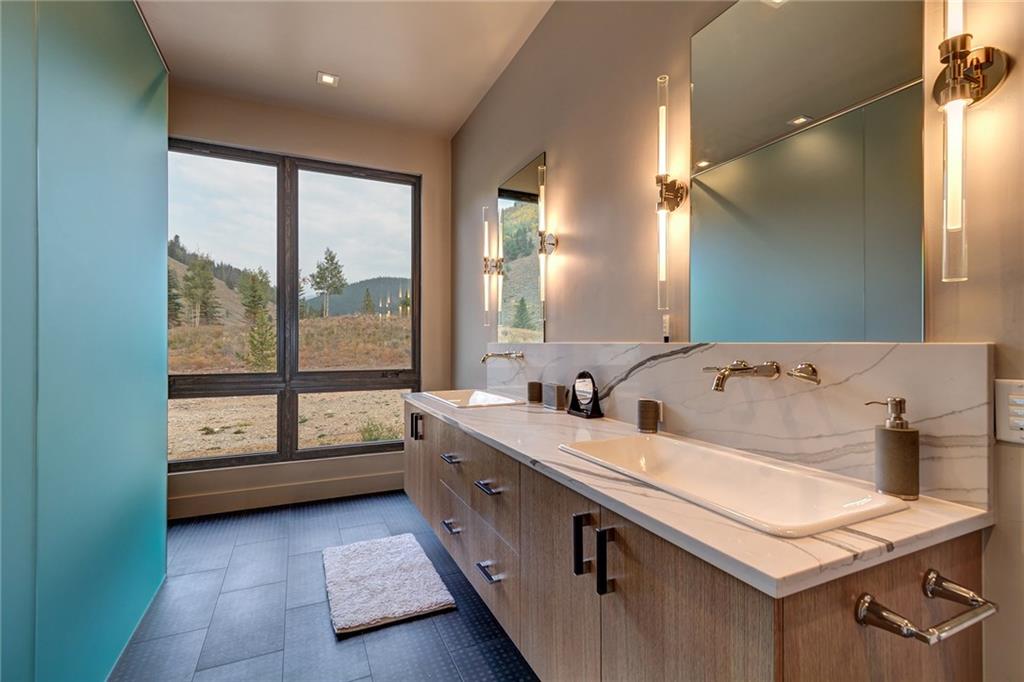 2989 Tiger Road Breckenridge, CO 80424 - Photo 17 of 30 a bathroom with a sink and a large mirror