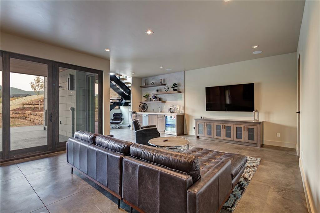 2989 Tiger Road Breckenridge, CO 80424 - Photo 22 of 30 a living room with furniture and a flat screen tv