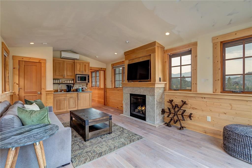 2989 Tiger Road Breckenridge, CO 80424 - Photo 26 of 30 a living room with furniture a fireplace and a flat screen tv