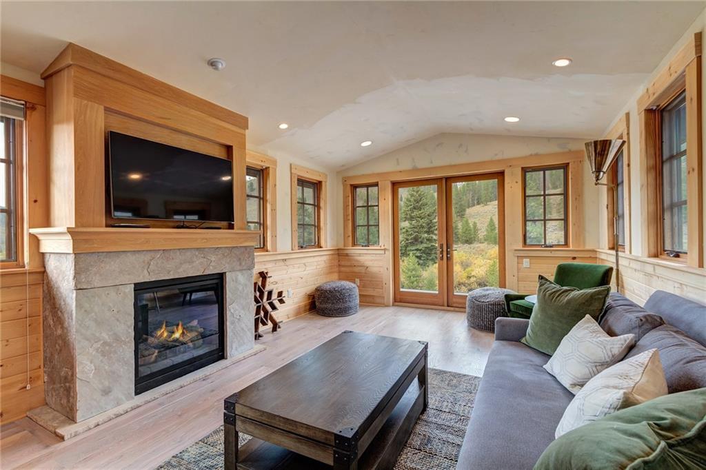 2989 Tiger Road Breckenridge, CO 80424 - Photo 27 of 30 a living room with furniture a flat screen tv and a fireplace