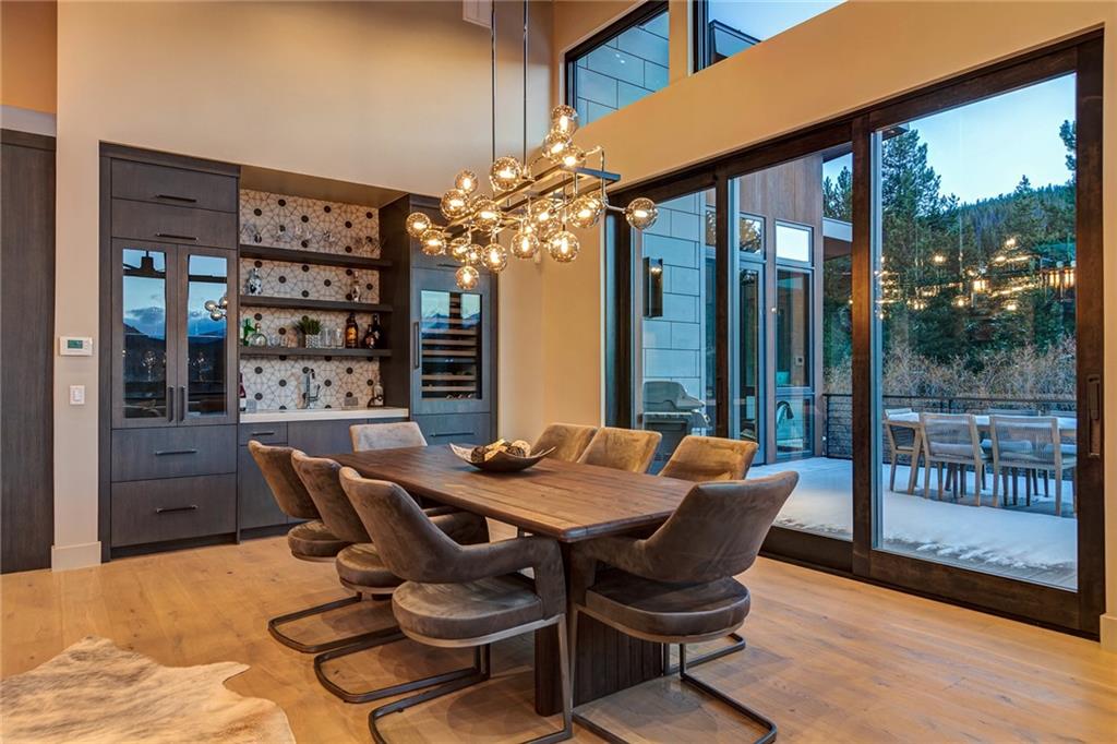 2989 Tiger Road Breckenridge, CO 80424 - Photo 6 of 30 a view of a dining room with furniture wooden floor and chandelier