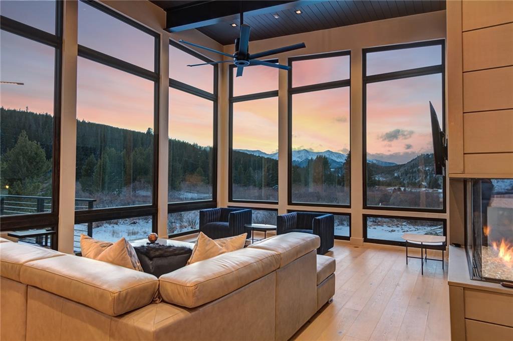 2989 Tiger Road Breckenridge, CO 80424 - Photo 8 of 30 a living room with furniture tv and a large window