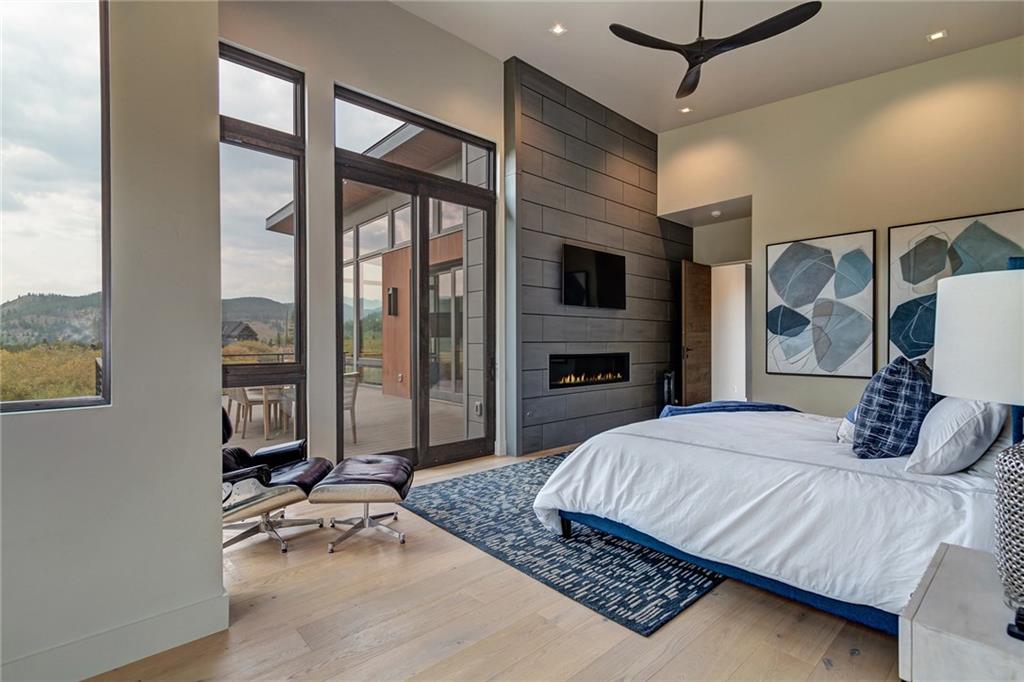 2989 Tiger Road Breckenridge, CO 80424 - Photo 10 of 30 a bedroom with a large bed and a flat tv screen