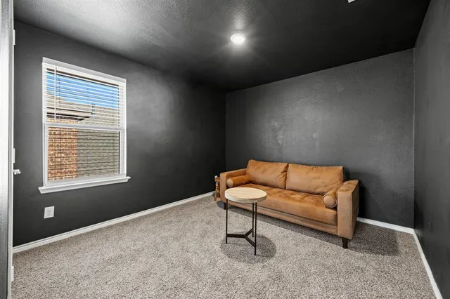 a couch sitting in a room next to a window