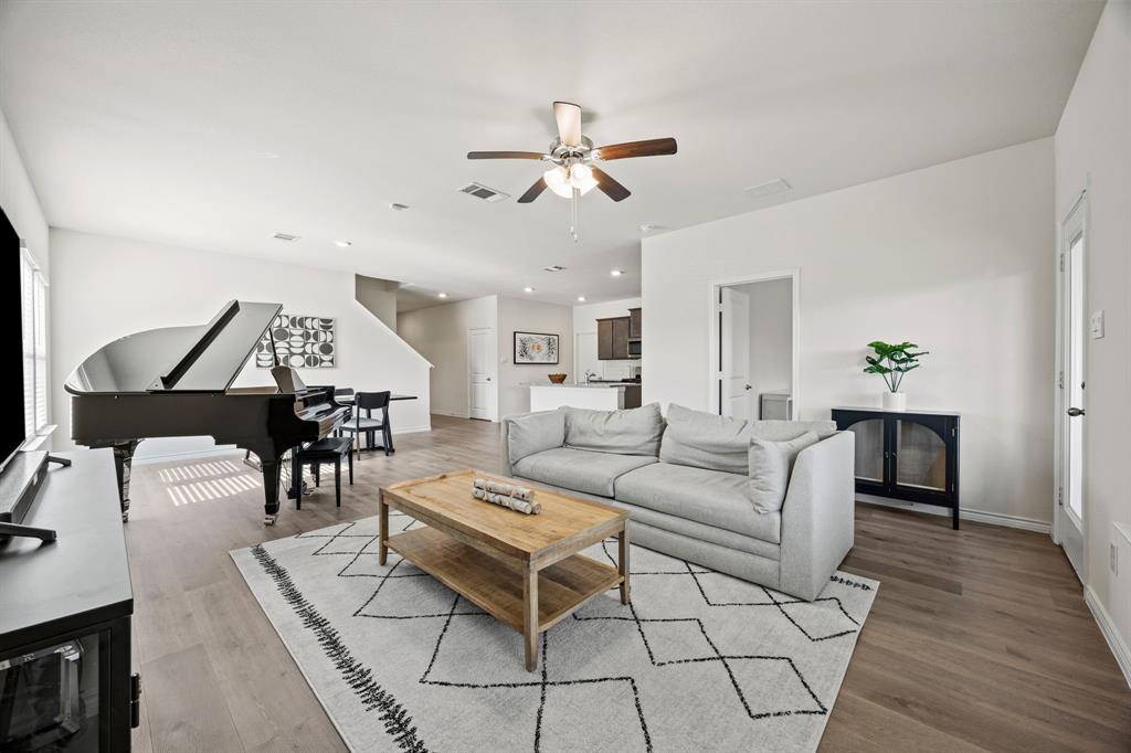 700 Cool Cyn Trail Princeton, TX 75407 - Photo 4 of 18 a living room with furniture a wooden floor and a ceiling fan