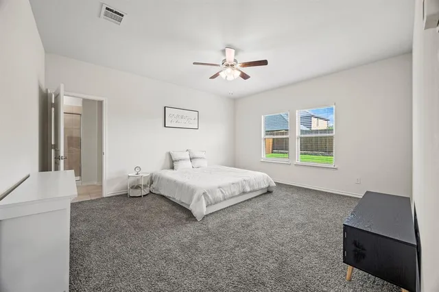 a spacious bedroom with a bed and a couch