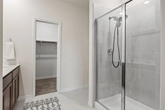 a bathroom with a shower and a sink
