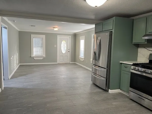 a view of kitchen with a refrigerator cabinets and a sink