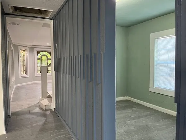 a view of an entryway with wooden floor and door
