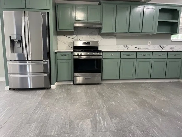 a kitchen with a sink and stainless steel appliances