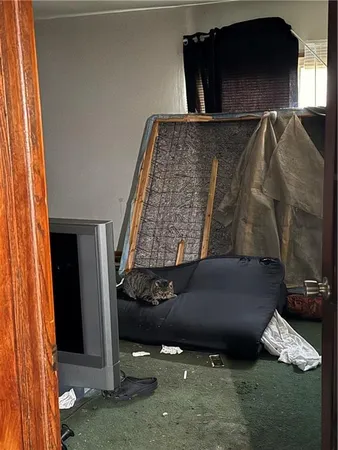 a kitchen with a refrigerator and a stove top oven