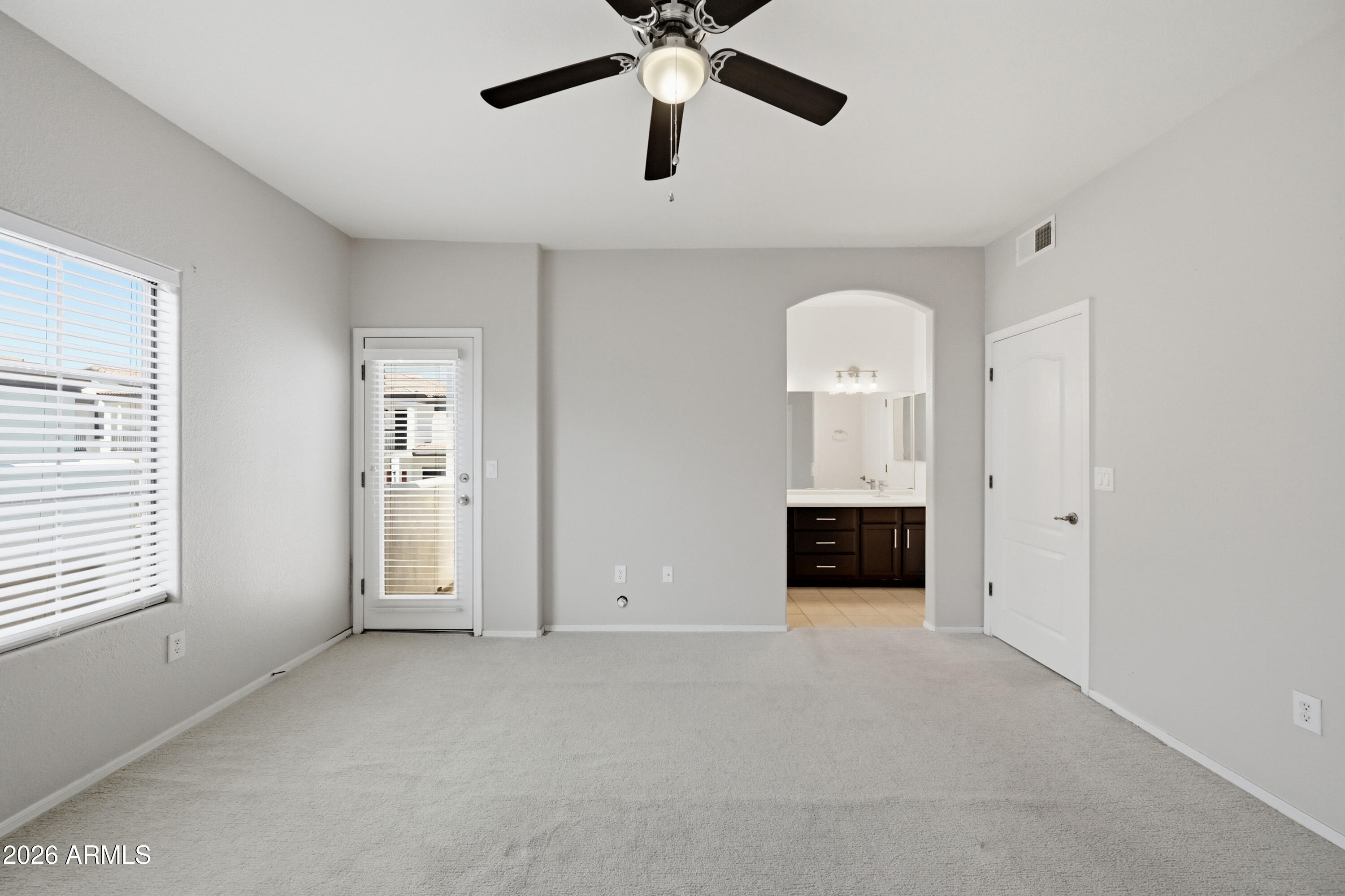 3150 East Beardsley Road, Unit 1009 Phoenix, AZ 85050 - Photo 24 of 31 a view of a livingroom with a chandelier fan and windows