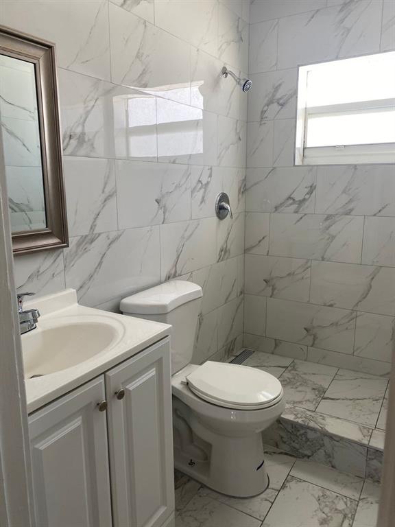3611 North Dixie Highway, Unit 3633 Oakland Park, FL 33334 - Photo 2 of 5 a bathroom with a toilet sink and a mirror