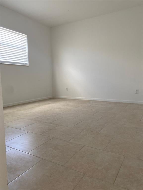 3611 North Dixie Highway, Unit 3633 Oakland Park, FL 33334 - Photo 3 of 5 a view of an empty room and window