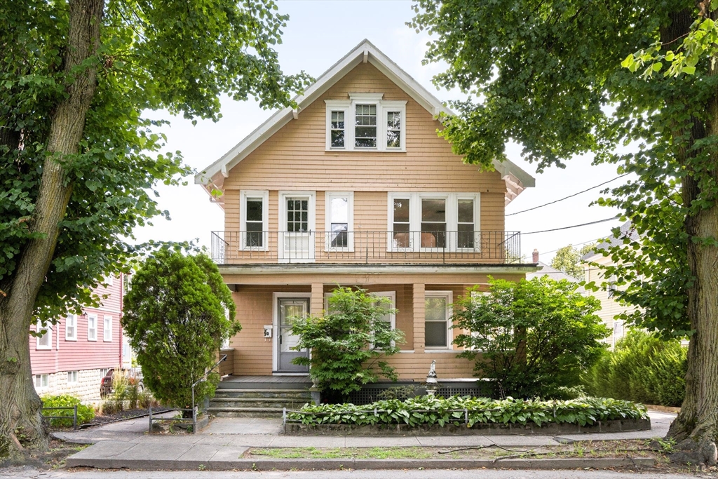 81-83 Everett Street Arlington, MA 02474 - Photo 1 of 1 a front view of a house with trees and plants