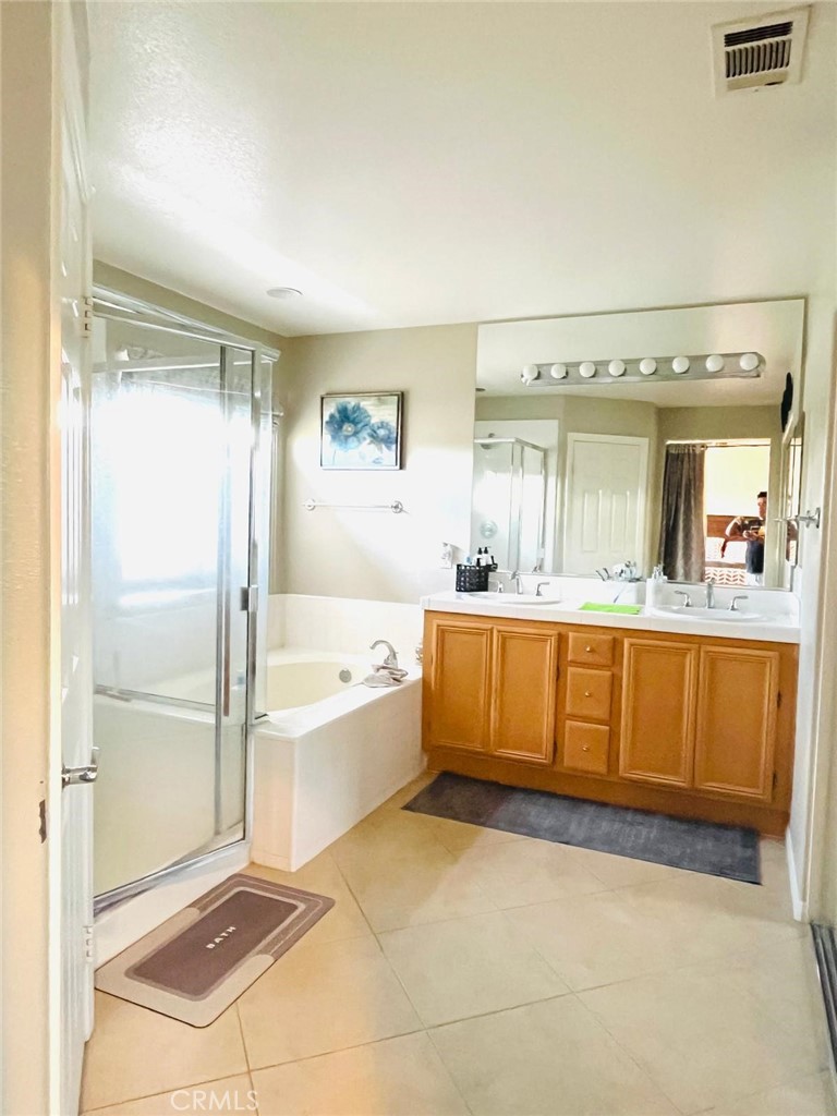 24336 Caladium Place Valencia, CA 91354 - Photo 11 of 25 a bathroom with a tub sink and mirror
