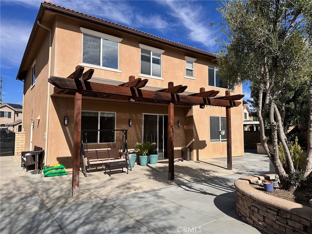 24336 Caladium Place Valencia, CA 91354 - Photo 23 of 25 a view of a house with backyard and sitting area