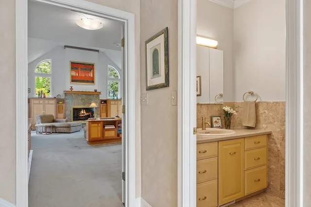 a en suite bathroom with a granite countertop sink and a mirror