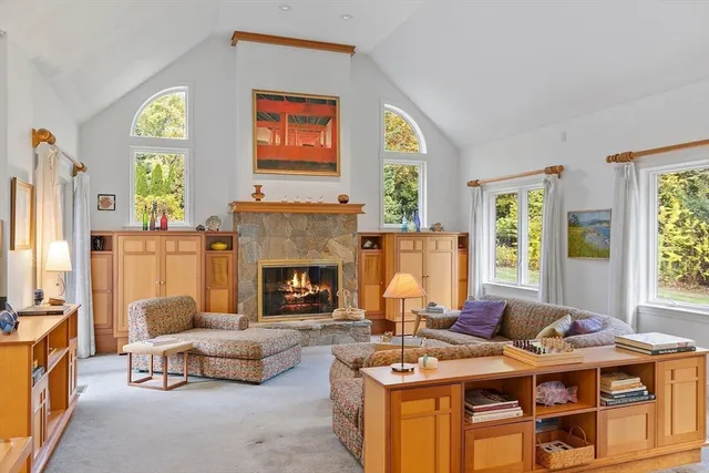 a living room with furniture fireplace and window