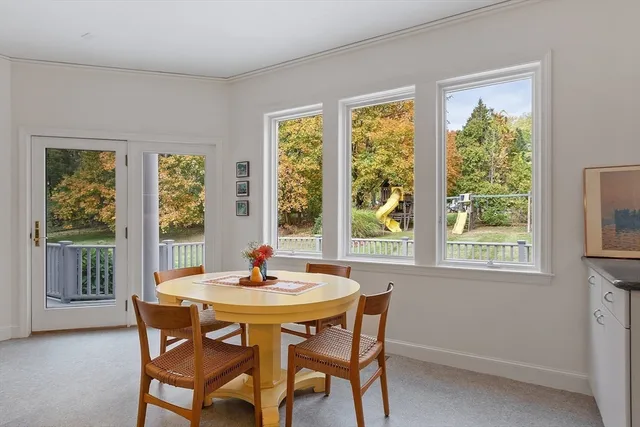 a dining room with furniture window and outside view